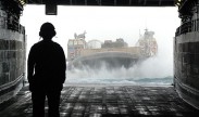 BoatswainÕs Mate 1st Class Marvin Tapper observes a landing craft air cushion (LCAC) as it approaches the well deck of the amphibious transport dock ship USS Green Bay (LPD 20). Green Bay is part of the Peleliu Amphibious Ready Group, with the embarked 15th Marine Expeditionary Unit (15th MEU), and is deployed in support of maritime security operations and theater security cooperation efforts in the U.S. 5th Fleet area of responsibility. (U.S. Navy Photo by Mass Communication Specialist 1st Class Elizabeth Merriam/Released)