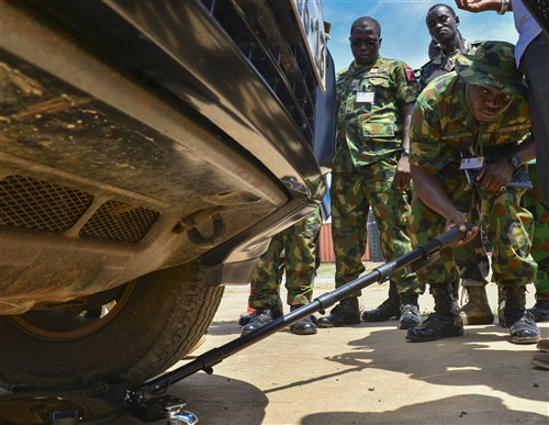 Nigerian air force squadron leader Sunkanmi Akinbohun, inspects a vehicle during the entry control familiarization portion of African Partnership Flight Ghana, Sept. 13, 2016, in Air Base Accra, Ghana. APF provides partner nations the opportunity to improve proficiency and readiness in key mission areas such as expeditionary airbase defense. (U.S. Air Force Staff Sgt. Stephanie Longoria/Released)