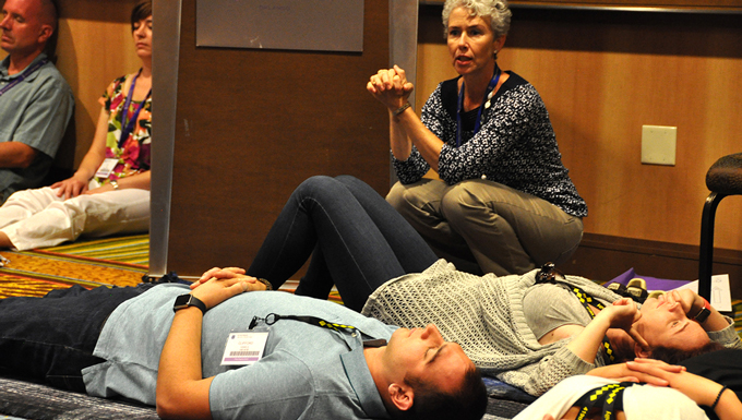 Emily Hain, Integrative Restoration and yoga instructor, monitors  Tech. Sgt. Clifford Daniels and wife Staff Sgt. Alexandra Daniels June 27, 2015, during a breakout session at an Air Force Reserve Yellow Ribbon Program training event in Orlando, Florida. (U.S Air Force photo/Master Sgt. James Branch)