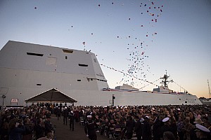 Balloons fly and the crowd applauds as the Navy's newest and most technologically advanced warship, USS Zumwalt (DDG 1000), is brought to life during a commissioning ceremony at North Locust Point in Baltimore.