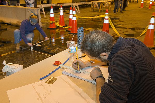 ALEXANDRIA, Va. (April 14, 2016) Blair Atcheson, left, Naval History and Heritage Command (NHHC) historical preservation coordinator, uses multiple rulers to take the length and curvature of a historical timber while Dr. Alexis Catsambis, cultural resource manager, records the information. NHHC Underwater Archaeology Branch (UAB) assisted city of Alexandria archaeologists with measuring and recording the remains of an 18th century ship after it was discovered at a construction site in Alexandria, Va. U.S. Navy photo by Mass Communication Specialist 1st Class Clifford L. H. Davis.