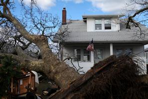 A United States flag flies in the background amidst debris and destruction caused by Hurricane Sandy in Toms River N.J.