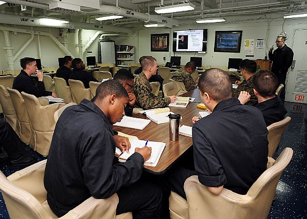 PACIFIC OCEAN (Feb. 24, 2016) Sailors and Marines attend an instructor-led college course facilitated by Gary Bretz, an embarked college professor in the ship's classroom aboard amphibious assault ship USS Boxer (LHD 4). Service members have the opportunity to attend voluntary education courses during their free time. More than 4,500 Sailors and Marines from Boxer Amphibious Ready Group, 13th Marine Expeditionary Unit (13th MEU) team are currently transiting the Pacific Ocean toward the U.S. 7th Fleet area of operations during a scheduled deployment. U.S. Navy photo by Mass Communications Specialist 1st Class Matthew N. Jackson.