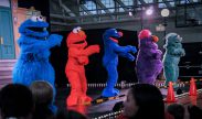 Sesame Street characters dance for children attending the Fort Meade, Maryland, showing of the Sesame Street/USO Experience for Military Families tour. DoD photo by Marine Corps Cpl. Cedric Haller.