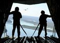 Airman Austin Metzler and Senior Airman Sean Zeringue, both C-130J Super Hercules loadmasters with the 61st Airlift Squadron, stand on the loading ramp of a C-130J during a training flight Nov. 10, 2015, above central Arkansas. The 19th Airlift Wing at Little Rock Air Force Base, Ark., is part of the Air Mobility Command and provides the Defense Department the largest C-130 fleet in the world. (U.S. Air Force photo/Senior Airman Harry Brexel)