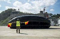 Petty Officer 3rd Class Kaitlyn Burch directs Landing Craft, Air Cushion (LCAC) 10 assigned to Naval Beach Unit (NBU) 7 to a landing spot on the tarmac.