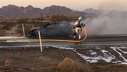 Crash fire and rescue Marines with Marine Wing Support Squadron 372, based out of Marine Corps Air Station, Yuma, Arizona, douse a car fire on U.S. Interstate 8, Oct. 7, 2016. The Marines noticed a compact car bellowing smoke on the westbound side of the interstate near exit 36 while in route to provide crash fire and rescue support at an auxiliary landing exercise for C-130 aircraft at Stoval Airfield, located approximately 50 miles east of Yuma.