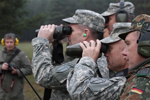 From back, Maj. Gen. Robert Brown, Col. Walter Piatt and Command Sgt. Maj. Steven McCaflin of the Maneuver Center of Excellence and Infantry School at Ft. Benning, Ga., watch snipers from the Bundeswehr at the German Infantry Academy in Hammelburg, Germany. The U.S. command team's visit was part of an exhibition of recent graduations of both U.S. and German Soldiers from the school's sniper course.