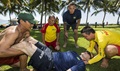 U.S. Navy Aviation Structural Mechanic 2nd Class Micah Rupp, (center), guides Vietnamese lifeguards in the correct procedures for moving a patient during a lifeguard community relations event held as part of Pacific Partnership 2016. Partner nations are working side-by-side with local organizations to conduct cooperative health engagements, community relation events and subject matter expert exchanges to better prepare for natural disaster or crisis. (U.S. Navy photo courtesy of the Royal Australian Air Force by Imagery Specialist Cpl. David Cotton)