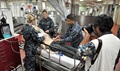 Sailors assigned to the hospital ship USNS Mercy demonstrate medical training procedures on a simulated patient.
