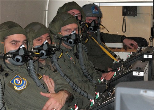 ROYAL NETHERLANDS AIR FORCE CENTER FOR MAN AND AVIATION, Netherlands &mdash; Students look on during a pre-flight brief in the high-altitude training chamber Feb. 7 at the Center for Man and Aviation in the Netherlands. The chamber simulates altitudes up to 30,000 feet and allows students to see firsthand the effects of hypoxia. (Department of Defense photo by Air Force Staff Sgt. Leigh Bellinger) 