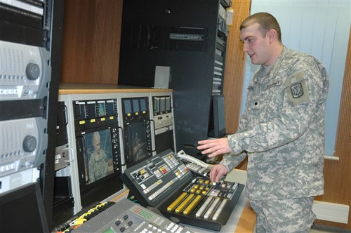 MAINZ, Germany &mdash; Army Spc. Anthony Scroggins, shown here performing duties as a broadcaster/producer with the American Forces Network-Hessen, was recognized for his valor and lifesaving actions by Mainz Police President Franz Kirchberger in a ceremony at the Mainz Police Headquarters here Feb. 1. Scroggins came to the aid of a stabbing victim by disarming the man’s attacker and neutralizing him until German police arrived.