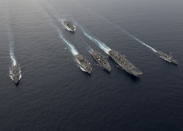 161013-N-SU278-229
South China Sea (Oct. 13, 2016) Clockwise from left, the guided-missile destroyer USS Spruance (DDG 111), the Military Sealift Command (MSC) ammunition and cargo ship USNS Washington Chambers (T-AKE 11), the guided-missile destroyer USS Decatur (DDG 73), the amphibious assault ship USS Bonhomme Richard (LHD 6), the Military Sealift Command (MSC) fleet oiler USNS Walter S. Diehl (T-AO 193) and the amphibious dock landing ship USS Germantown (LSD 42) steam in formation as part of interoperability drills between the Pacific Surface Action Group (PAC SAG) and Bonhomme Richard Expeditionary Strike Group (BHR ESG) in the South China Sea Sea, Oct. 13, 2016. The drills are meant to enhance readiness of cruiser-destroyer ships to rapidly integrate with an amphibious task force to provide increased capability for amphibious operations in support of crisis response or disaster relief. (U.S. Navy photo by Petty Officer 2nd Class Will Gaskill) 
