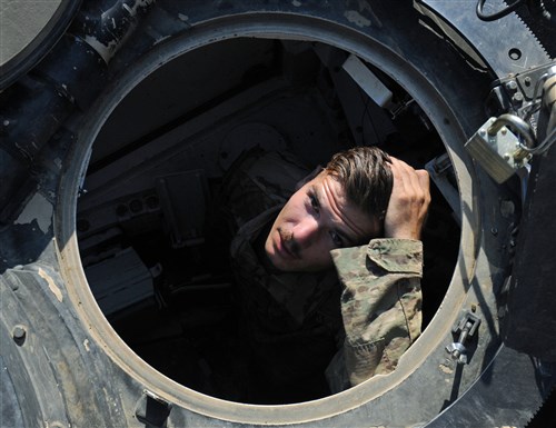 NOVO SELO TRAINIG AREA, Bulgaria – SPC Jonathan Cyr, Anvil Company, 1st Combined Arms Battalion, 64th Armor Regiment looks up from the hull of his tank July 21, 2016 as he gets ready to head out to the field with his company. The unit will spend 11-days in the field conducting platoon and company level situational training exercises (STX). 1st Bn., 64th Arm. Rgmt. is in Bulgaria in support of Operation Atlantic Resolve, a U.S. led effort in Eastern Europe that demonstrates U.S. commitment to the collective security of NATO and enduring peace and stability in the region.