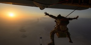 A pararescueman jumps from an aircraft