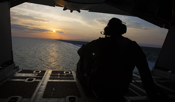 An Air Force loadmaster assigned to the 15th Special Operations Squadron watches the sunset from the back of an MC-130H Combat Talon II during Exercise Emerald Warrior 16, May 12, 2016, at Hurlburt Field, Fla. Air Force photo by Staff Sgt. Matthew B. Fredericks
