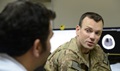 Service Member talking with a man. Source: U.S. Air Force photo by Master Sgt. Cohen A. Young/Released