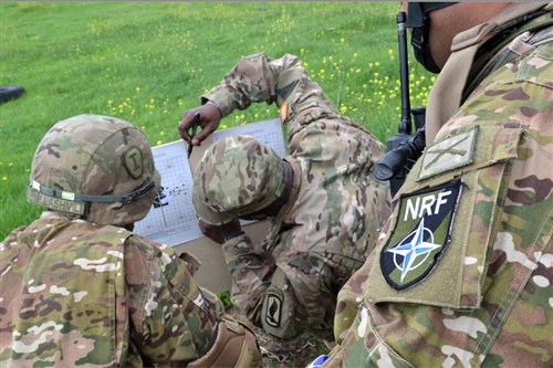 Staff Sgt. Raymi Wright, a paratrooper with Troop C, 1st Squadron, 91st Cavalry Regiment, 173rd Airborne Brigade, works with Georgian soldiers during a combined weapons range here May 14, 2015, as part of Exercise Noble Partner. Noble Partner is a field training and live-fire exercise between the U.S. Army and the Georgian military to support Georgia's participation in the NATO Response Force and build military ties between the two nations. (U.S. Army photo by Sgt. A.M. LaVey/173rd Abn. PAO)
