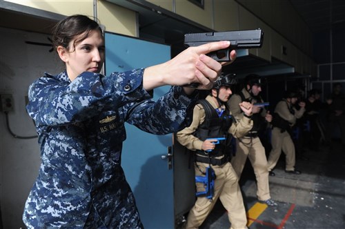 SOUDA BAY, Greece - Lt. Kim Manuel, left, participates in a small-arms course aboard the Hellenic navy training ship Aris at the NATO Maritime Interdiction Operational Training Center during Eurasia Partnership Capstone 2012 (EPC 12). Annually hosted by the U.S. Navy, EPC aims to increase maritime safety and security through workshops and seminars. Nations participating in EPC include Azerbaijan, Bulgaria, Georgia, Greece, Romania, Ukraine and the United States.