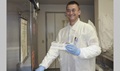 U.S. Army Spc. Chris Springer flashes a smile as he puts some of his work into one of the facility’s many refrigerators. (DoD photo by Katie Lange)