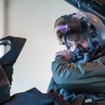 1st Lt. Jared Tew, 35th Fighter Squadron pilot, puts on his helmet before taxiing during RED FLAG-Alaska 15-1 at Eielson Air Base, Oct. 16, 2014. This field training exercise is focused on improving the combat readiness of U.S. and international forces and providing training for units preparing for air expeditionary force tasking. (U.S. Air Force Photo by Senior Airman Taylor Curry/Released)