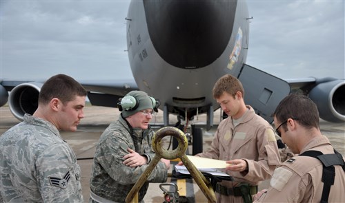 (Left to right) Senior Airman Michael Warren and Tech. Sgt. Michael Mackey, both with the 100th Aircraft Maintenance Squadron, review maintenance logs and the flight plan with 1st Lt. John Lachiewicz and Capt. Tim Gerne, both with the 351st Expeditionary Air Refueling Squadron, prior to their flight on March 17, 2013.