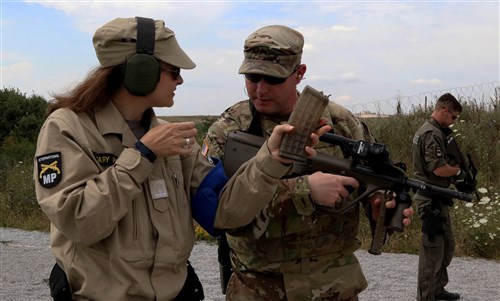 A member of the Kosovo Force (KFOR) International Military Police conducts preliminary marksmanship instruction with Sgt. Anthony Smith, a military policeman assigned to Multinational Battle Group-East, during a multinational marksmanship training exercise held on Camp Bondsteel, Kosovo, July 26, 2016. U.S. and NATO forces have contributed to the United Nations-mandated peacekeeping mission in Kosovo since June 1999.
(U.S. Army photo by: Staff Sgt. Thomas Duval, Multinational Battle Group-East Public Affairs)