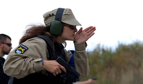 A member of the Kosovo Force (KFOR) International Military Police force in Kosovo aligns herself with the target before firing her pistol during marksmanship training held on Camp Bondsteel, Kosovo, July 26, 2016. U.S. and NATO forces have contributed to the United Nations-mandated peacekeeping
mission in Kosovo since June 1999. (U.S. Army photo by: Staff Sgt. Thomas Duval, Multinational Battle Group-East Public Affairs)