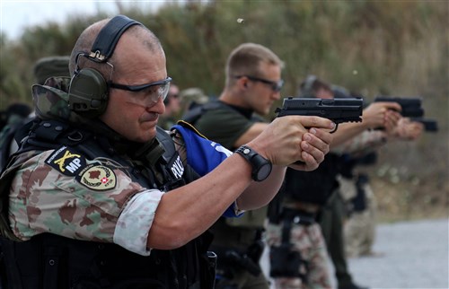 A member of the Kosovo Force (KFOR) International Military Police fires at a target during marksmanship training held on Camp Bondsteel, Kosovo, July 26, 2016.U.S. and NATO forces have contributed to the United Nations-mandated peacekeeping mission in Kosovo since June 1999. (U.S. Army photo by: Staff Sgt. Thomas Duval, Multinational Battle Group-East Public Affairs)
