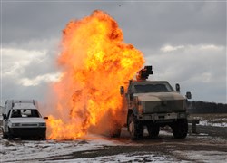 A German Army Dingo vehicle drives through a simulated roadside bomb blast during joint training with the 421st Multifunctional Medical Battalion at Baumholder Training Area Feb. 20. This training helps meet the goal of U.S. Army Europe to strengthen the interoperability of our partner nation land forces and set conditions to build coalitions for future overseas contingency operations.