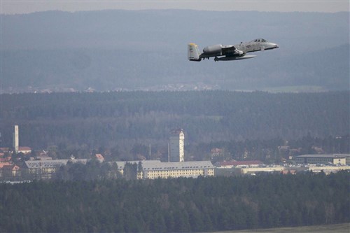 GRAFENWOEHR, Germany – A U.S. Air Force A-10 Thunderbolt from the 81st Fighter Squadron, Spangdahlem Germany, makes a final flight over the Joint Multinational Training Command’s Grafenwoehr Training Area, Apr 24, 2013.  In the background is the iconic Grafenwoehr Water Tower. The A-10 attack aircraft made its first flight over the Grafenwoehr Training Area on Aug. 25, 1977.