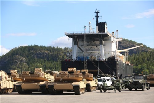 M1A1 Abrams Main Battle Tanks and other vehicles and equipment are staged for transportation at the designated offload pier during a pre-planned Single Ship Movement and offload of military equipment from a Maritime Prepositioning Force ship in the Trøndelag region of Norway.
 
U.S. Marines from 2nd Marine Logistics Group out of Camp Lejeune, NC, in coordination with their Norwegian counterparts, are modernizing some of the equipment currently stored within six caves as a part of the Marine Corps Prepositioning Program-Norway by placing approximately 350 containers of gear and nearly 400 pieces of heavy rolling stock into the storage caves.
 
Specific equipment which will greatly increase the program's readiness includes M1A1 Main Battle Tanks, Tank Retrievers, Armored Breeching Vehicles, Amphibious Assault Vehicles, Expanded Capacity Vehicle (ECV) Gun Trucks and several variants of the MTVR 7-1/2 ton trucks.