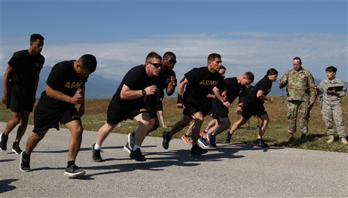 Soldiers from the Multinational Battle Group-East kick off day one of the Best Warrior Competition, July 9, at Camp Bondsteel, Kosovo. Day one consists of a physical fitness test, situational training lanes and a writing exam. (U.S. Army photo by: Staff Sgt. Thomas Duval, Multinational Battle Group-East public affairs)