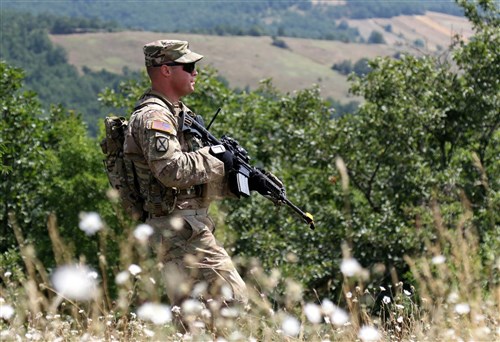 Staff Sgt. Daniel Dalton, squad leader with the 1st Battalion, 41st Infantry Regiment, 2nd Infantry Brigade Combat Team, patrols a ridge line during a squad-level situational training exercise held in Dumnice, Kosovo, July 25, 2016. The purpose of the exercise was to train individual squad movements in preparation for a larger scale operation deemed Iron Eagle, later this year. (U.S. Army photo by: Staff Sgt. Thomas Duval, Multinational Battle Group-East Public Affairs)