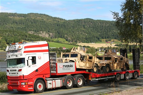 Armored variants of the M1114 High Mobility Multipurpose Wheeled Vehicle (HMMWV) are transported by truck from a ship offload location to one of six caves which make up the Marine Corps Prepositioning Program-Norway during an equipment modernization operation.
 
U.S. Marines from 2nd Marine Logistics Group out of Camp Lejeune, NC, in coordination with their Norwegian counterparts, are modernizing some of the equipment by placing approximately 350 containers of gear and nearly 400 pieces of heavy rolling stock into the storage caves. 

Specific equipment which will greatly increase the program's readiness includes M1A1 Main Battle Tanks, Tank Retrievers, Armored Breeching Vehicles, Amphibious Assault Vehicles, Expanded Capacity Vehicle (ECV) Gun Trucks and several variants of the MTVR 7-1/2 ton trucks.
