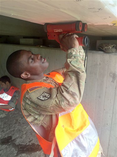 Staff Sgt. Kwayne Huggins, a combat engineer with 10th Engineer Battalion, 1st Armored Brigade Combat Team, 3rd Infantry Division, scans a bridge to locate and assess the steel reinforcement as part of a bridge assessment near Ingolstadt, Germany July 14. Soldiers from the battalion joined engineers from ten NATO countries for an International Bridge Assessment Course to inform Soldiers on the different existing bridge assessment methods.