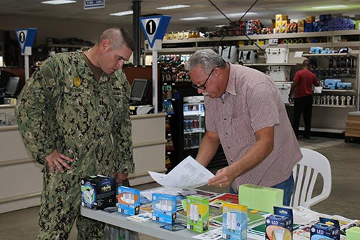 SANTA RITA, Guam (Oct. 14, 2016) -- Karl Dreikorn, U.S. Naval Base Guam (NBG) Installation Energy Manager (right), explains some of the energy conservation initiatives at NBG to Lt. James Guthrie, NBG Security Officer, during an Energy Awareness display at the Navy Exchange Home Store, Oct. 14.  Highlights of NBG's energy initiatives include the awarding of a $15.6 million contract to upgrade Heating, Ventilation and Air Conditioning (HVAC) units.  Eleven U.S. Naval Base Guam (NBG) facilities will
soon receive ENERGY STAR-certified HVAC units with new high performance technology and high-energy efficient Variable Refrigerant Flow (VRF) systems, resulting in an annual savings of more than $1.38 million. Work is planned to begin in January or February 2017.