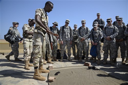 U.S. Army Reserve Officer Training Corps cadets watch as a Djiboutian Army weapons instructor teaches them how to safely field strip an AK-47 at the Djiboutian Army Academy in Arta, Djibouti, July 25, 2016. After the cadets learned the fundamentals, they competed with each other to see who could field strip the weapon quickest. (U.S. Air Force photo by Staff Sgt. Benjamin Raughton/Released)