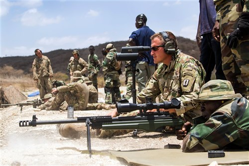 U.S. Army Master Sgt. Mac Broich, an instructor with the Vermont Army National Guard’s Regional Training Institute, observes rounds for a soldier from the Senegalese Army’s 1st Paratrooper Battalion at a range July 13, 2016 in Thies, Senegal as part of Africa Readiness Training 2016. ART 2016 is a U.S. Army Africa exercise designed to increase U.S. and Senegalese readiness and partnership through combined infantry training and live fire events.  (U.S. Army Africa photo by Spc. Craig Philbrick/Released)