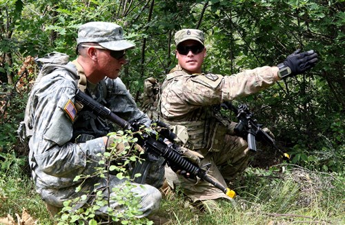 Staff Sgt. Daniel Dalton, squad leader with the 1st Battalion, 41st Infantry Regiment, 2nd Infantry Brigade Combat Team, assigns security positions to his team during a squad-level situational training exercise held in Dumnice, Kosovo, July 25, 2016. The purpose of the exercise was to train individual squad movements in preparation for a larger scale operation deemed Iron Eagle, later this year. (U.S. Army photo by: Staff Sgt. Thomas Duval, Multinational Battle Group-East Public Affairs)
