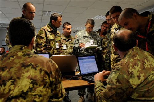 American and Italian technicians work to establish network connections during exercise Combined Endeavor 2010. The exercise was held at the Joint Multinational Training Command (JMTC) in Grafenwoehr, Germany.  JMTC has the only Battle Command Center (BCTC) and supporting facilities certified by the Joint Forces Command to conduct joint training. (U.S. Air Force Photo/Staff Sgt. Tim Chacon)