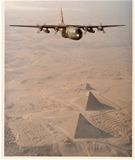 A C-130 of the 130th Tactical Airlift Group, West Virginia Air National Guard, flies over the Pyramids of Giza, Egypt, 1981.