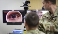 In a demonstration of the Telehealth process at Fort Campbell's Blanchfield Army Community Hospital, clinical staff nurse Army Lt. Maxx P. Mamula examines mock patient Army Master Sgt. Jason H. Alexander using a digital external ocular camera. 