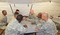 Maj. Alexander Ragan, center, a Littleton, Colo., native and the behavioral health officer for the Headquarters and Headquarters Company, 36th Engineer Brigade, sits with Soldiers of 104th Engineer Company, 62nd Engineer Battalion, 36th Eng. Bde., at the end of his weekly stress management class before the Soldiers transition out of Liberia to a controlled monitoring area, Jan. 8, 2015, at the National Police Training Academy, Paynesville, Liberia during Operation United Assistance. Ragan said he educated Soldiers on the importance of supporting each other, the battle buddy system, and approaches to recognize signs and symptoms of Soldiers who are struggling. Operation United Assistance is a Department of Defense operation in Liberia to provide logistics, training and engineering support to USAID-led efforts to contain the Ebola virus outbreak in western Africa. (U.S. Army photo by Sgt. Ange Desinor, 13th Public Affairs Detachment /RELEASED)