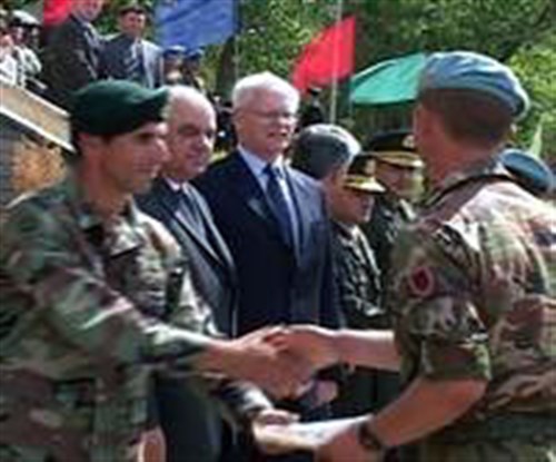 An Albanian commando, right, and fellow commandos, receive congratulations 
Thursday after completing their first phase of training with U.S. Special Forces. From left, offering their congratulations, are: U.S. Army Capt. Chris Robishaw, Special Forces team leader of the 1st Battalion, 10th Special Forces Group; Albanian President Alfred Moisiu; and U.S. Ambassador to Albania James Jeffrey. 
(Photo courtesy of USAF )