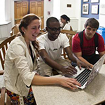 College students working with their teacher.