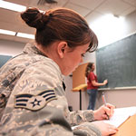 Service member taking notes in a class