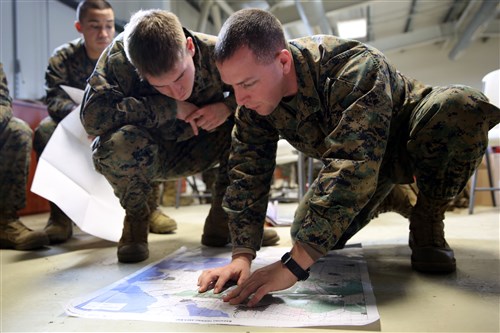 Sergeant Geoffrey Wisman, a supply clerk with Black Sea Rotational Force 14, and Lance Cpl. Justin Garn, a military policeman with BSRF-14, review their map during a land navigation class in Mihail Kogalniceanu, Romania Jan. 9, 2014. Participants have received classes on land navigation, combat lifesaving, the combat orders process, improvised explosive device indicators and Marine Corps history, customs and courtesies.