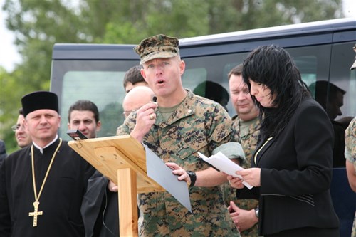 MIHAIL KOGALNICEANU AIRFIELD, Romania- Marine Lt. Col Tom Gordon, the commander of the Security Cooperation Marine Air-Ground Task Force deployed for Black Sea Rotational Force 2010, addresses attendees of the opening ceremony, May 17.  â?Our mission over the next three months will be to conduct multilateral security cooperation activities with partner nations in the Black Sea, Balkan, and Caucasus regions in order to enhance our collective professional military capacity, promote regional stability, and build enduring relationships with our partner nations,,â? said Gordon at the ceremony. (U.S. Marine Corp photo by Staff Sgt. Christopher Flurry)