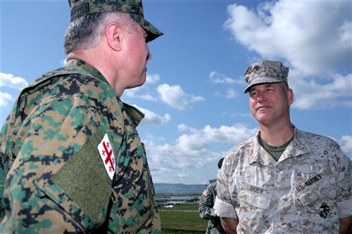 KRTSANISI, Georgia &mdash; Brig. Gen. Paul W. Brier, commander of Marine Forces Europe and Marine Forces Africa, discusses the Georgia Deployment Program training with the base commander during a visit to the Krtsanis Training Area (KTA). Marines with Marine Corps Training and Advisory Group (MCTAG) have been working with infantry battalions from the Republic of Georgia Armed Forces to train them for deployments to Afghanistan in support of International Security and Assistance Forces there. During his two-day visit, Brig. Gen. Brier also attended a ceremony marking the historic deployment of the Georgian 31st Light Infantry Battalion to support Marine Expeditionary Brigade Afghanistan. The 31st Battalion has been training with Marines from Marine Forces Europe and MCTAG for the past six months as the first of four Georgian battalions participating in the Georgia Deployment Program. The deployment marks the first time a foreign military force will deploy as part of a Marine Regimental 